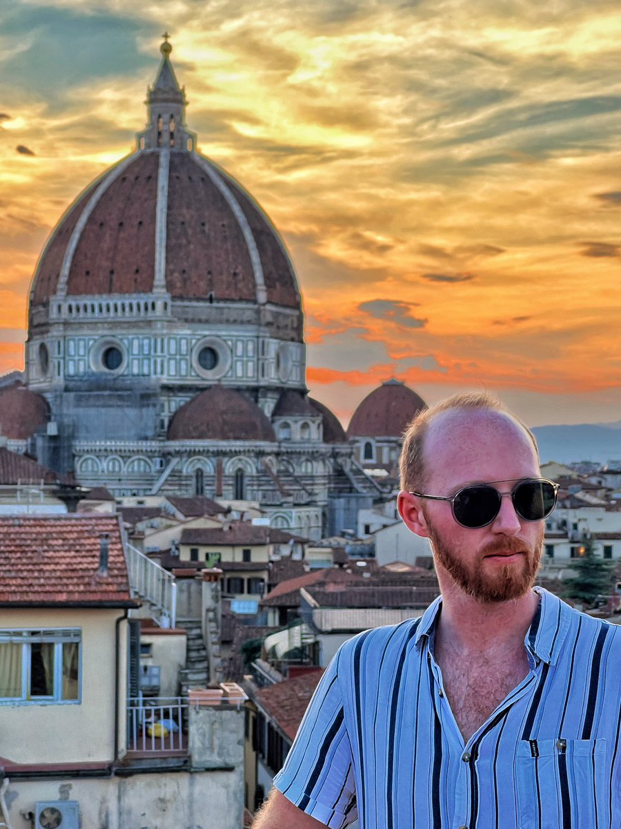 Florence under intense summer sun with traveller in hat and sunglasses