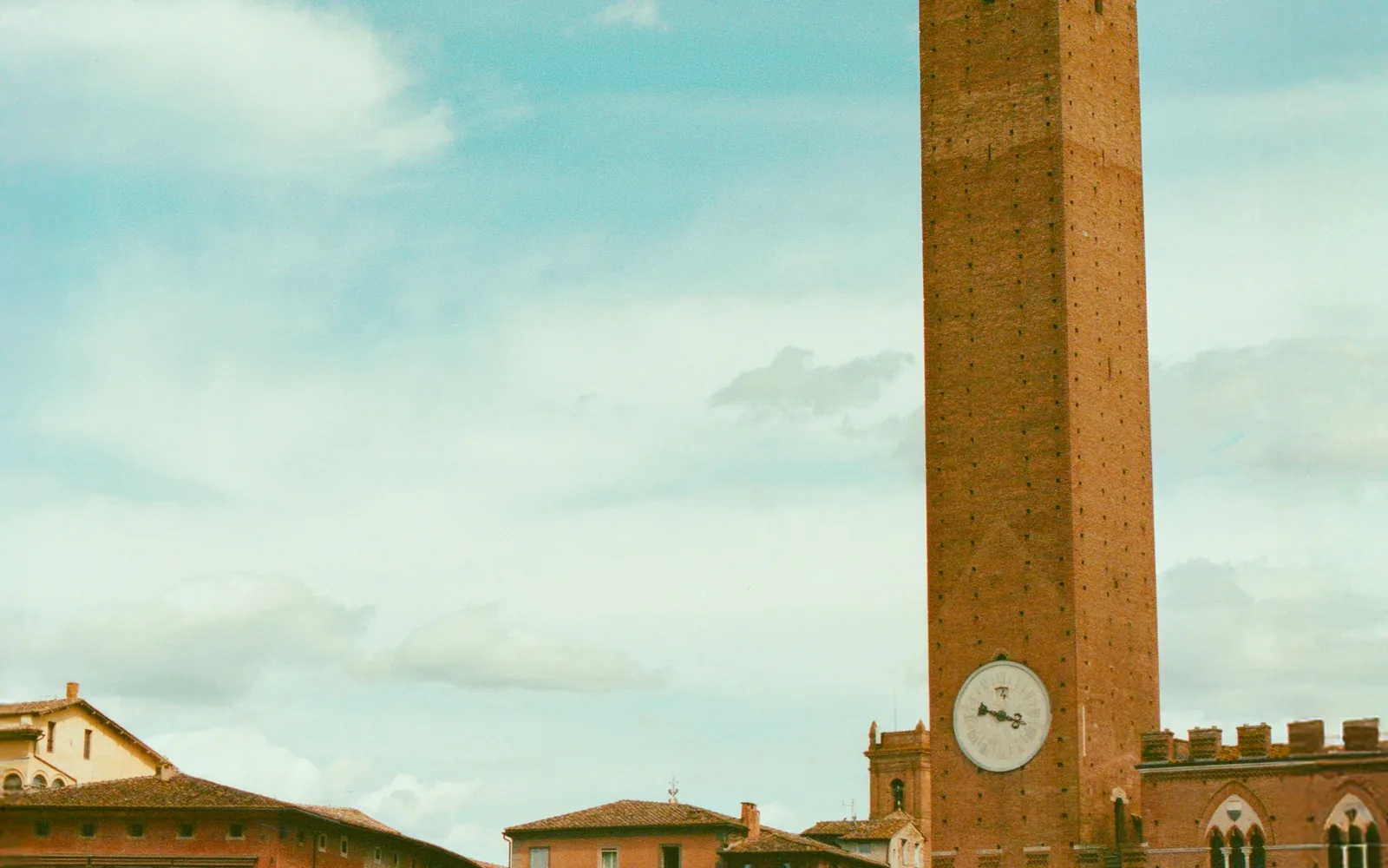 Torre del Mangia rising above Piazza del Campo under a clear sky